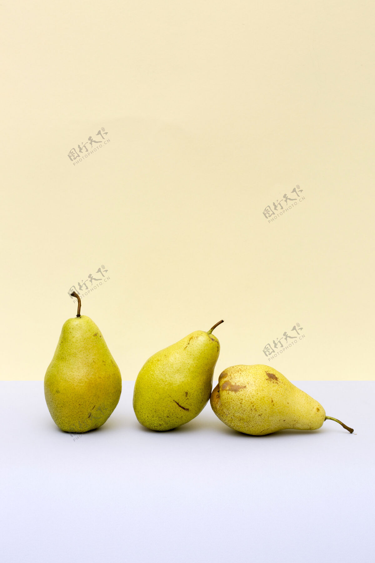 米色三个成熟的梨在彩色背景上形状灰色位置