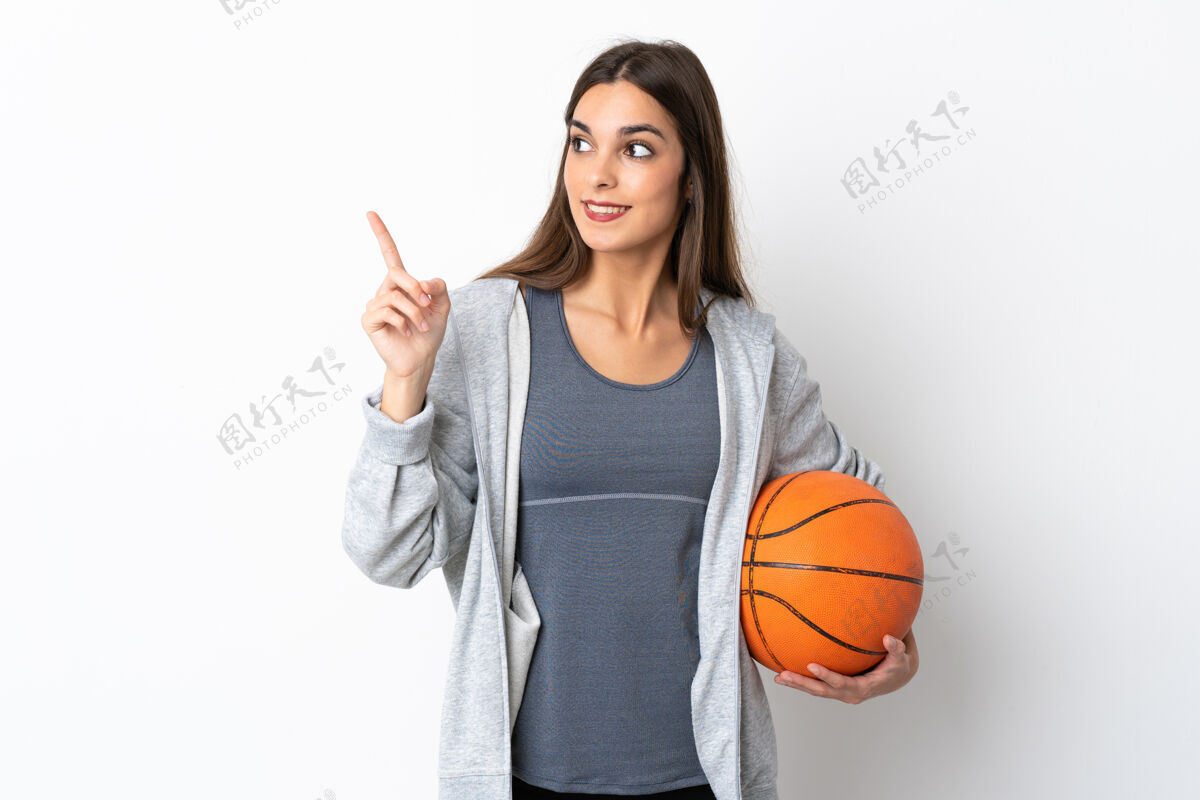 沉思年轻女子在白色背景上孤立地打篮球 想在举手之劳的同时实现解决方案球微笑成人