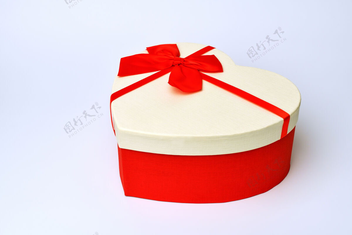 节日心形礼品盒与红色丝带站在中间的蓝灰色表面周年纪念约会包装