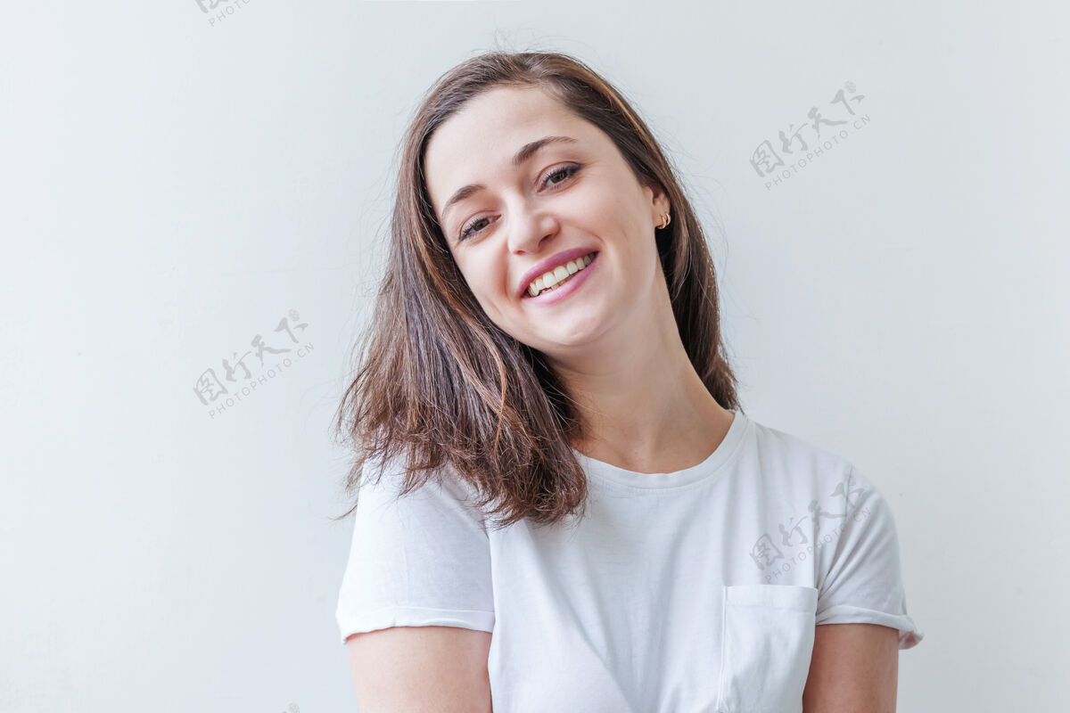 白色背景快乐的女孩微笑美丽的肖像年轻快乐积极的黑发女子隔离在白色背景上朋友微笑自由