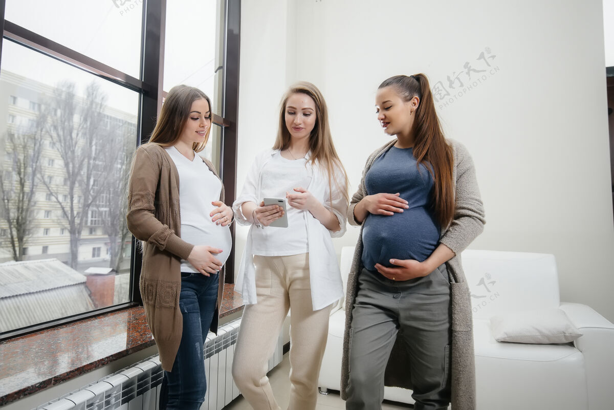 团聚一群年轻的孕妇在产前课堂上交流孕妇的护理和咨询产妇期待电话