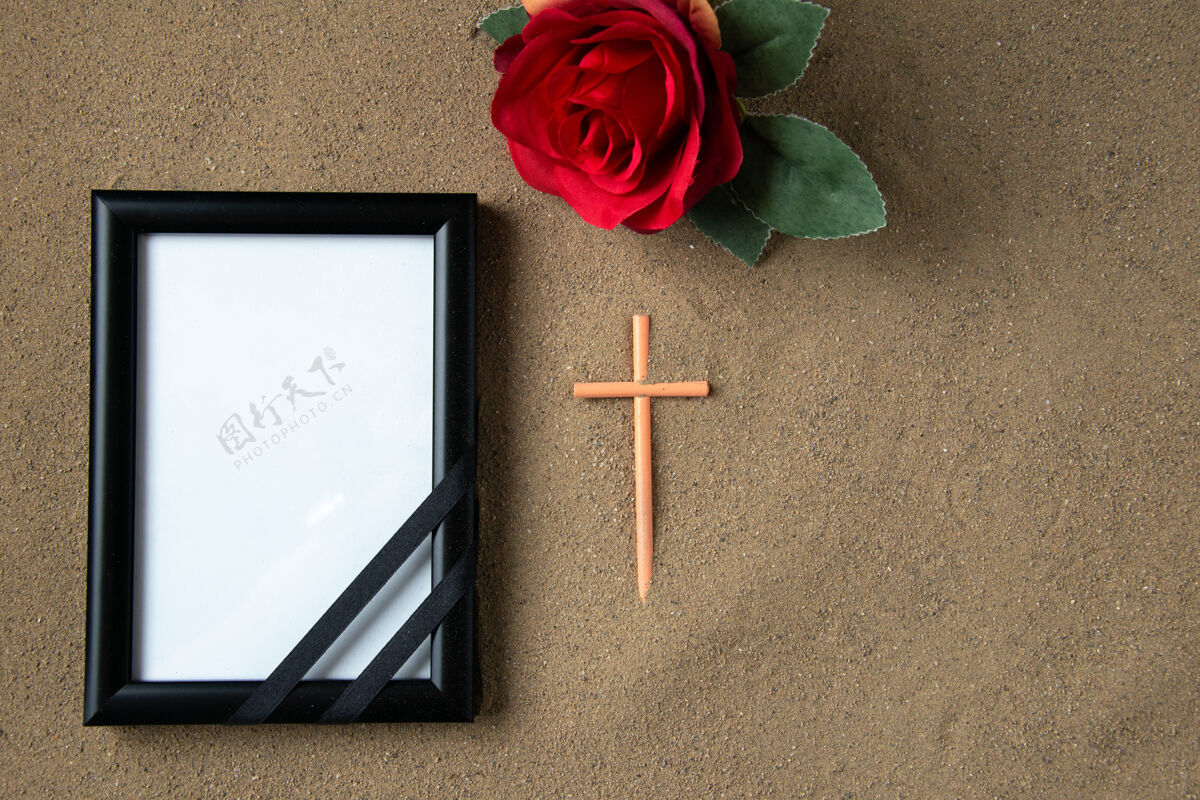 顶用红花和相框在沙死亡葬礼巴勒斯坦棒十字架俯视图图画情人节浪漫