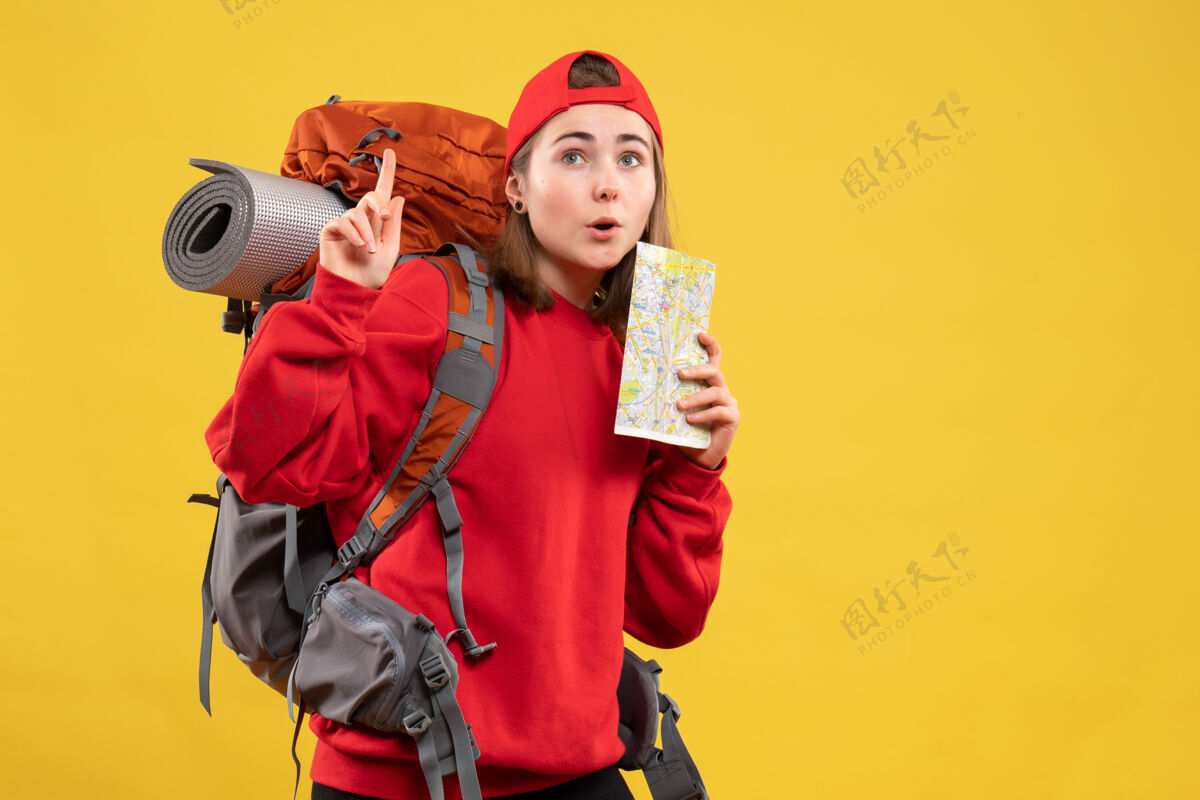 成人正面图可爱的女旅行者背着背包拿着地图指着天花板男性指向地图
