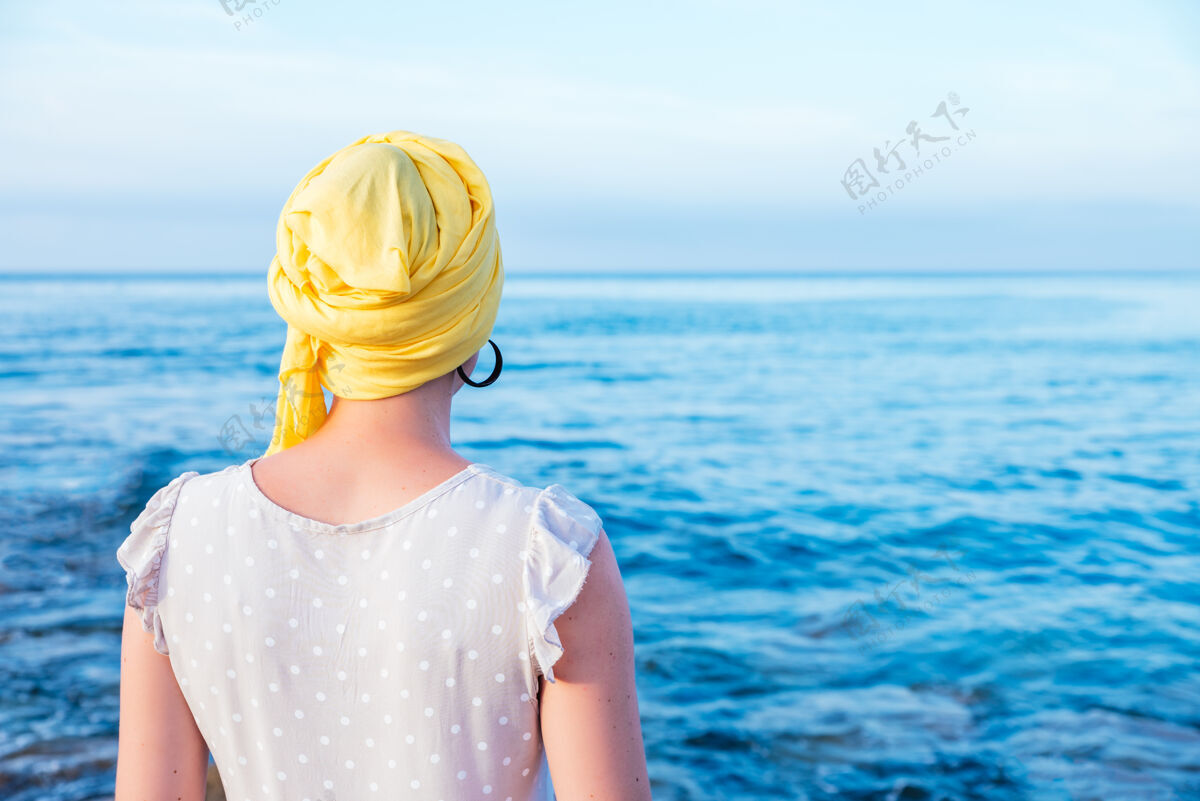 材料戴着黄领巾的女人在欣赏海景疾病考试温暖