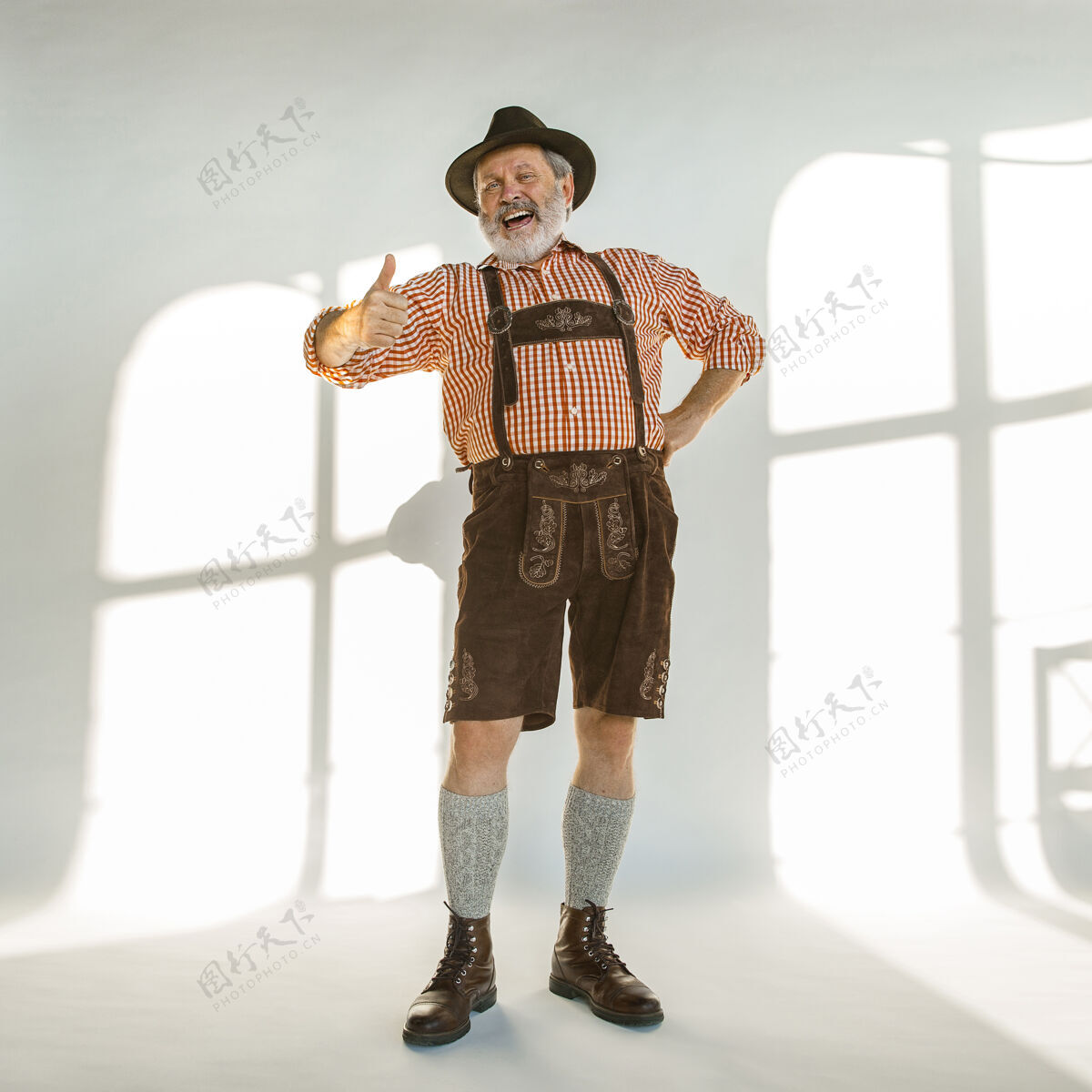 酒精啤酒节高级男士的肖像 戴着帽子 穿着传统的巴伐利亚服装白色背景的男性全长摄影棚庆祝 节日 节日的概念快乐的呼唤啤酒节日酒馆