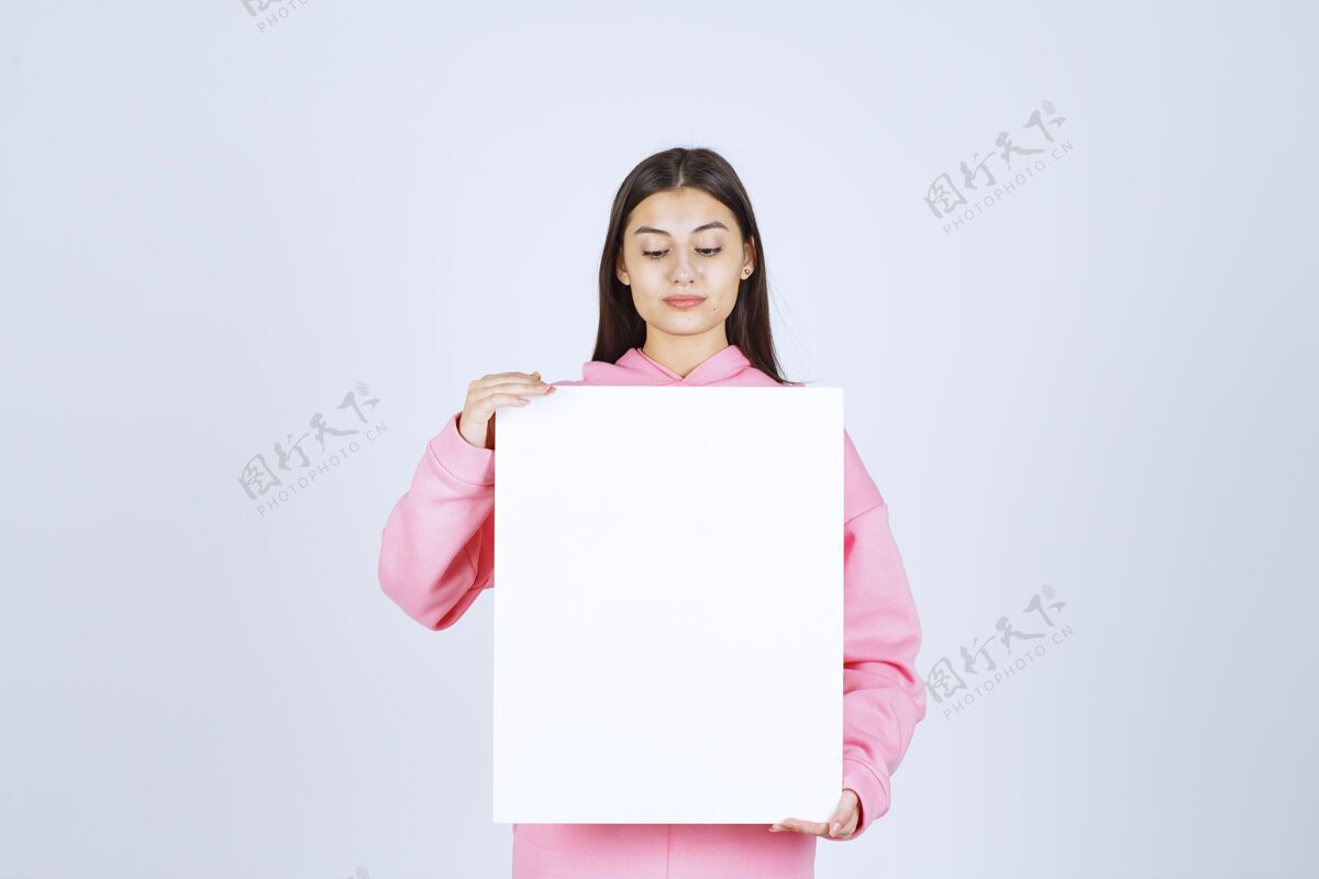 服装穿着粉色睡衣的女孩 手里拿着一块空白的方形展示板项目模特促销
