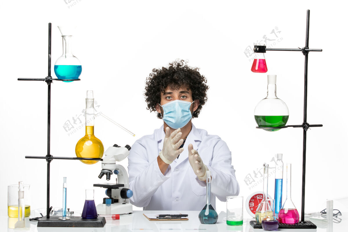 男性正面图男性化学家穿着白色的医疗服 戴着面罩坐在白色的空间里医学西装医生