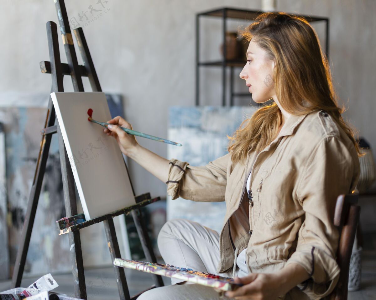 中镜头中等身材的女人用画笔画画工匠艺术家画家