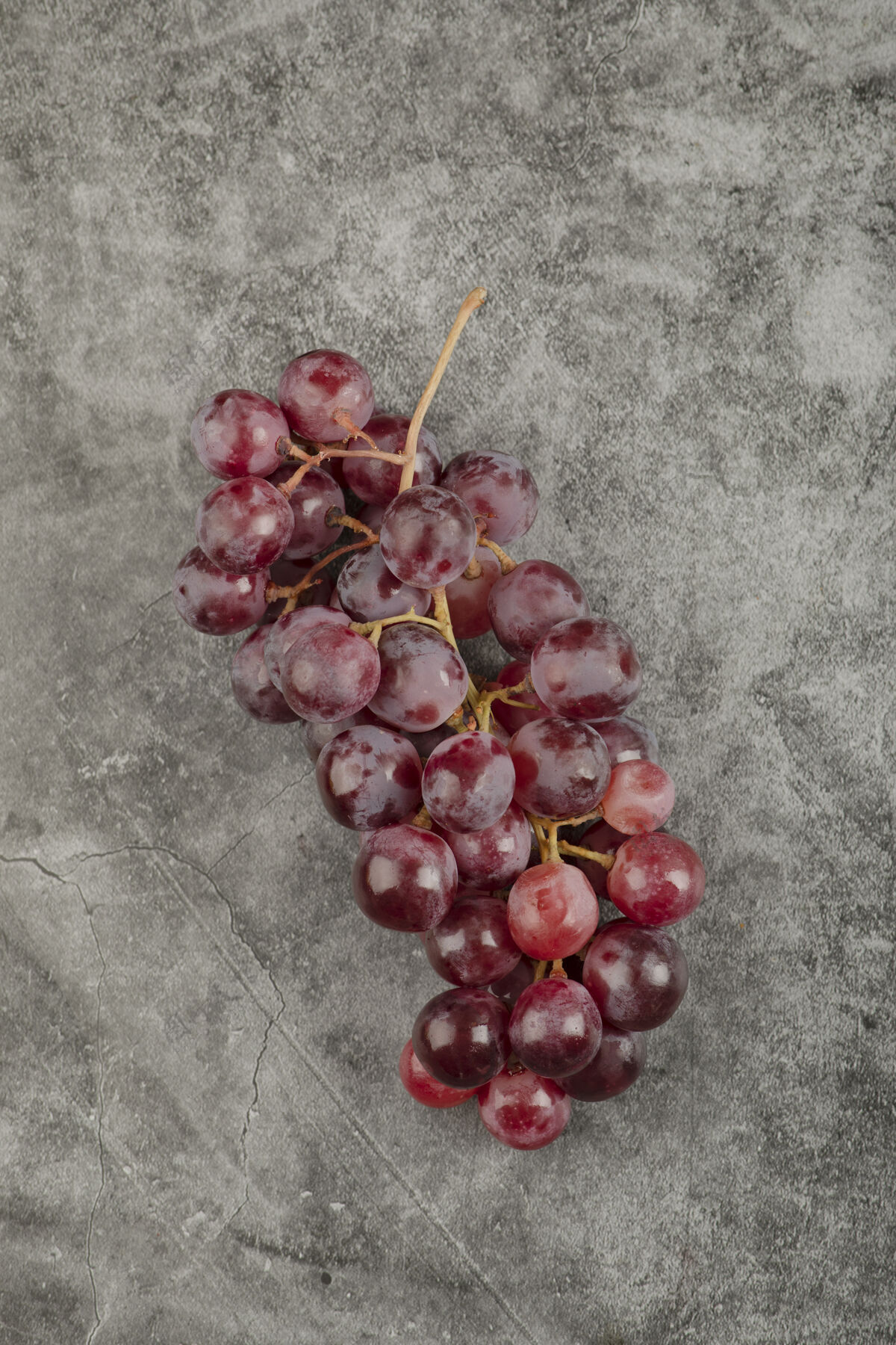 水果大理石表面有一簇簇新鲜成熟的红色葡萄明亮食物果汁