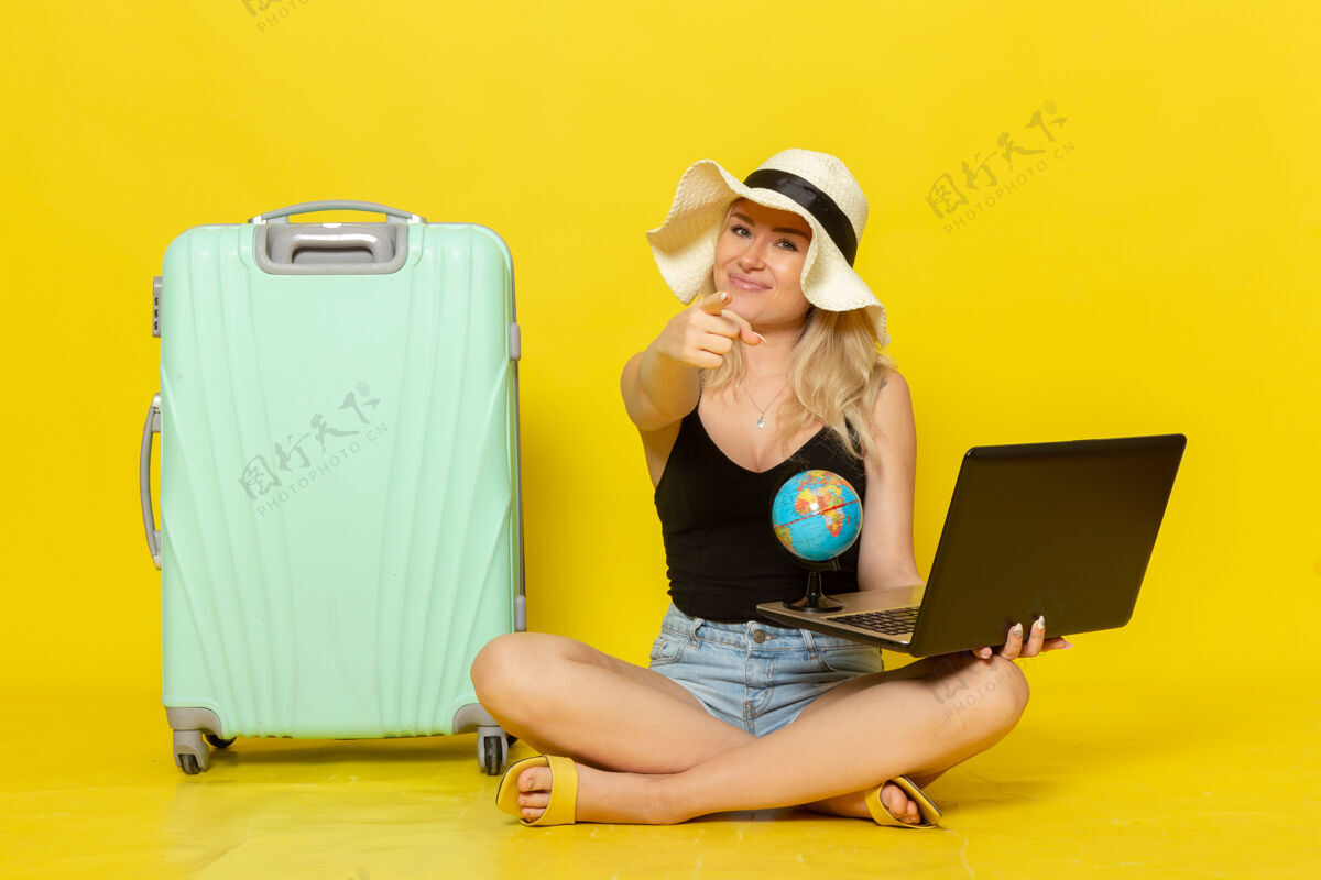 黄色前视图年轻女性拿着她的笔记本电脑女人旅行旅行