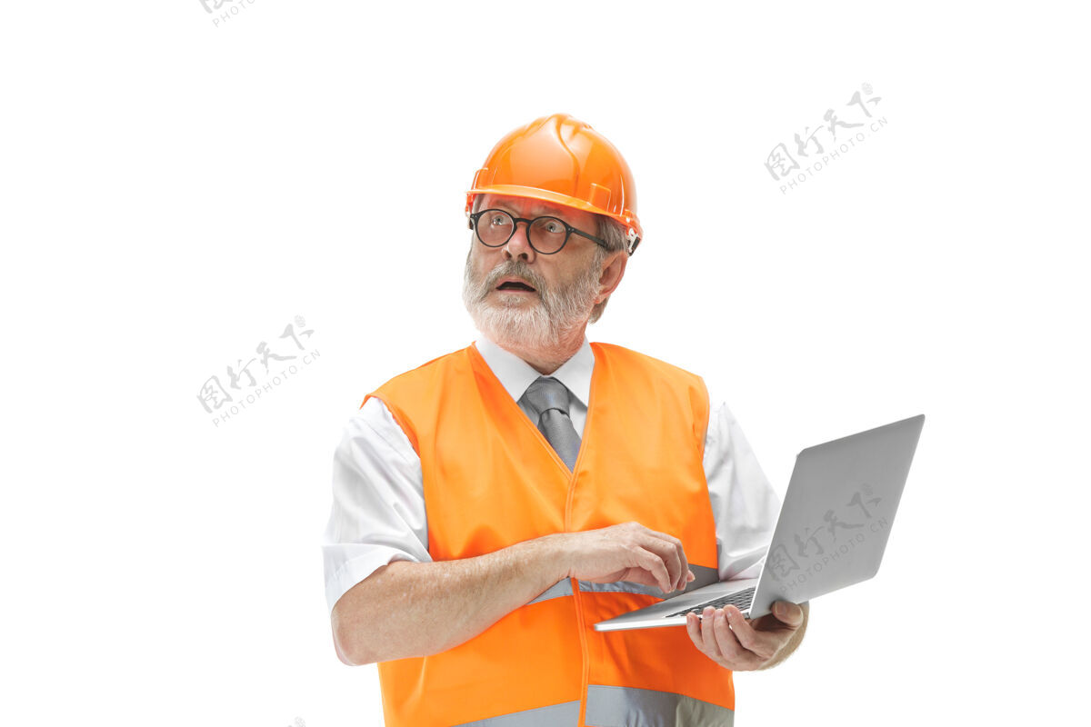 工人穿着建筑背心 戴着橙色头盔 带着笔记本电脑的建筑工人人员男性计划