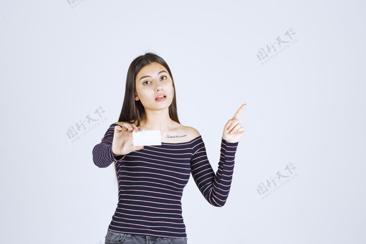 服装穿条纹衬衫的女孩拿着名片指着别人人类人体模特休闲