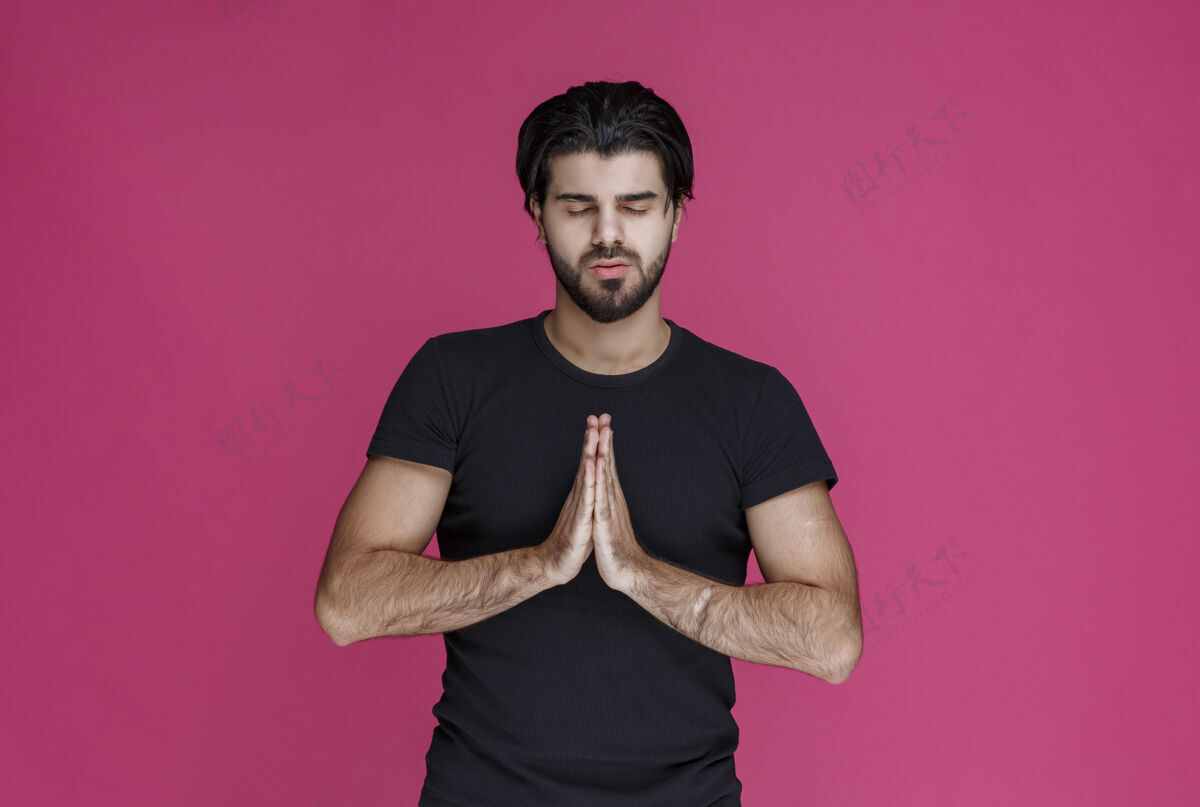 愿望穿黑衬衫的男人在祈祷 梦想着什么宗教祈祷年轻人