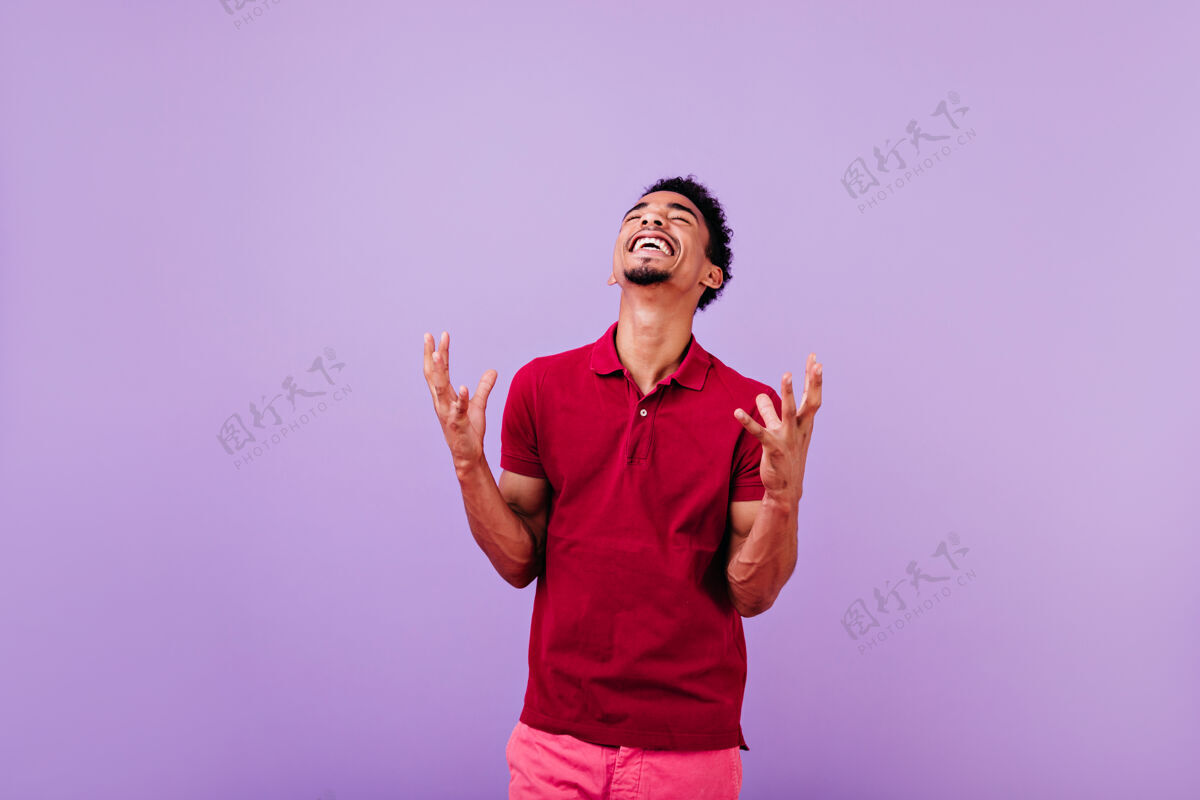 休息帅气的黑人表达幸福无忧无虑的黑发红衫男人成人现代紫色