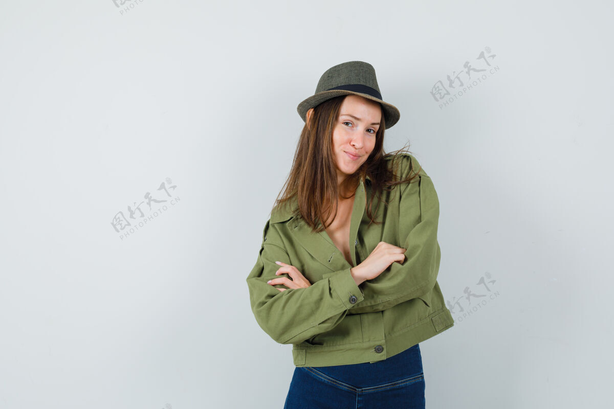 手臂年轻的女士交叉双臂站在夹克裤子帽子 看起来很优雅夹克连衣裙人类