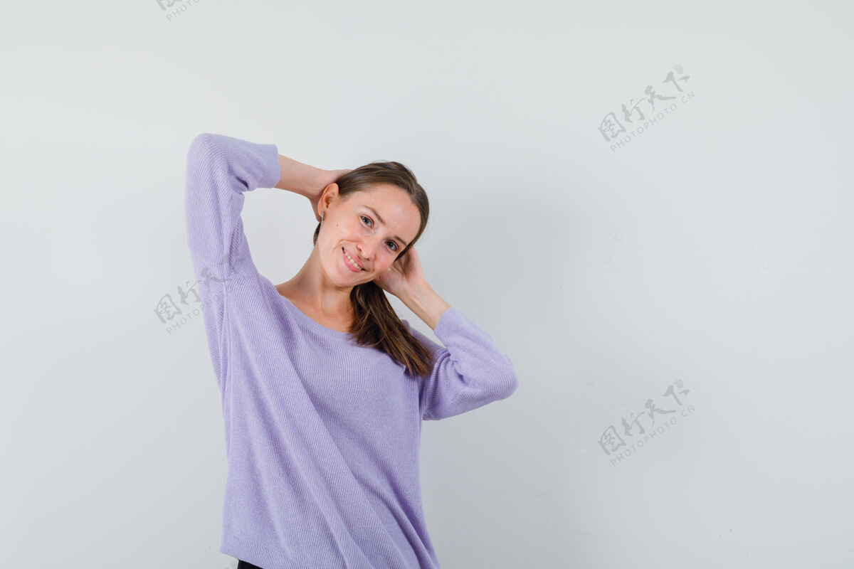 化妆一位身穿淡紫色上衣的年轻女性手放在头上摆姿势 看上去很快乐新鲜黑发漂亮