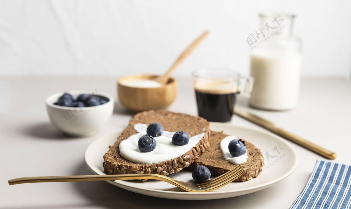 烹饪高角度的烤面包放在盘子里 配上蓝莓和牛奶液体切片早餐
