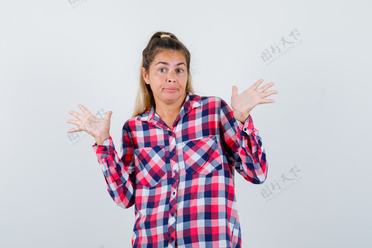 手掌照片中的年轻女士穿着格子衬衫 双手呈投降姿势 脸上一片迷茫女人脸女人