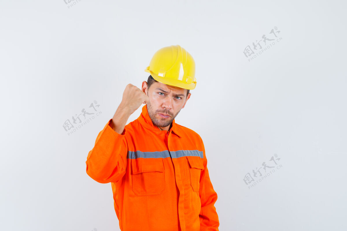 建设者身穿制服的施工人员握紧拳头 头戴钢盔 看上去自信满满 前视尽收眼底土建拳头设备