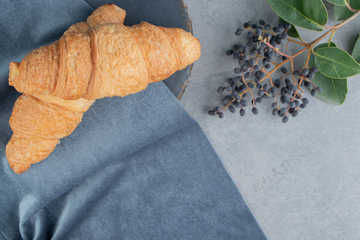 糖羊角面包放在毛巾上 葡萄放在大理石地板上 大理石背景上高质量的照片美味糕点美味