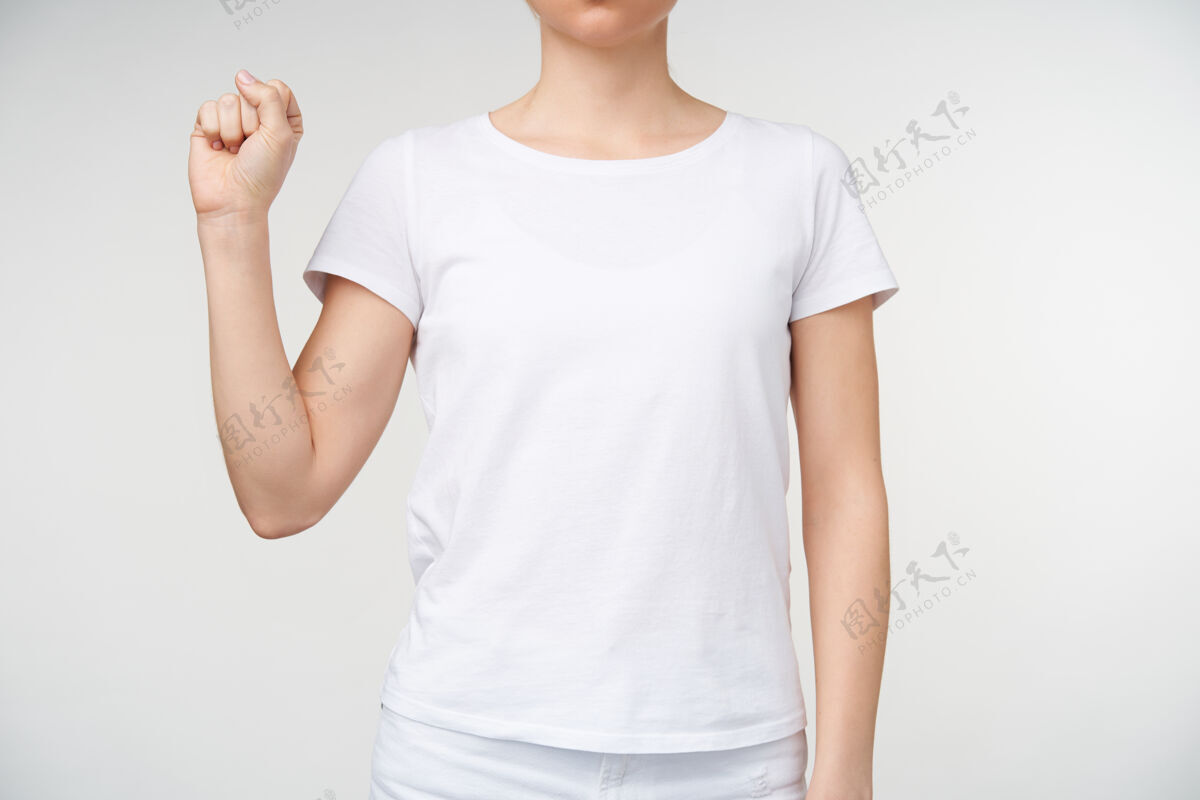 女性一张剪下来的照片 年轻女性穿着基本的白色t恤 紧握着她的手 同时用手语显示字母s 站在白色背景上站立室内身体