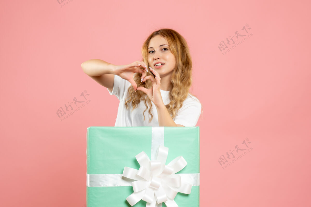 丝带正面图年轻女子站在蓝色礼品盒内送爱心年轻女性人蓝色