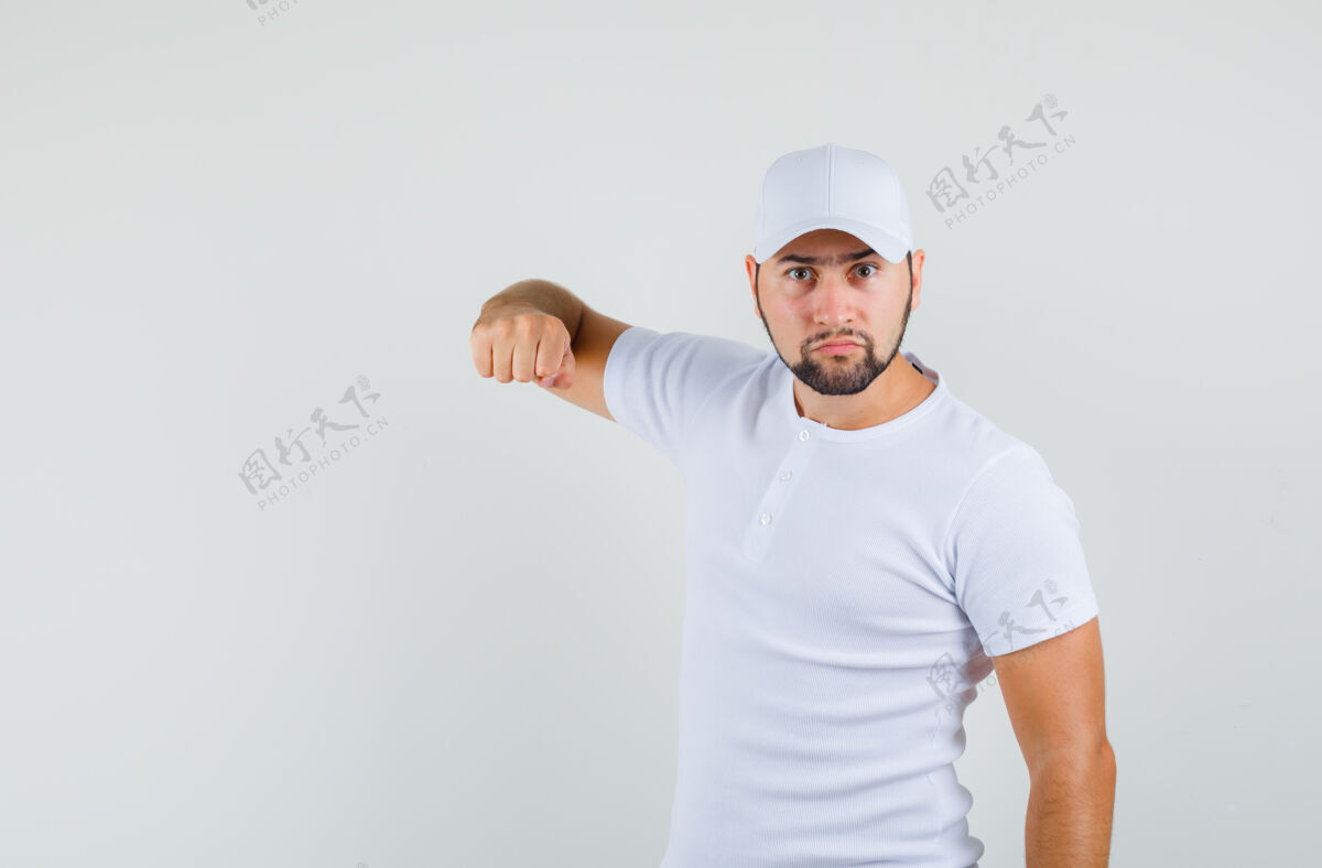 手势一个穿着t恤 戴着帽子的年轻人 指着摄像机 怒气冲冲地看着前方成人男士衬衫