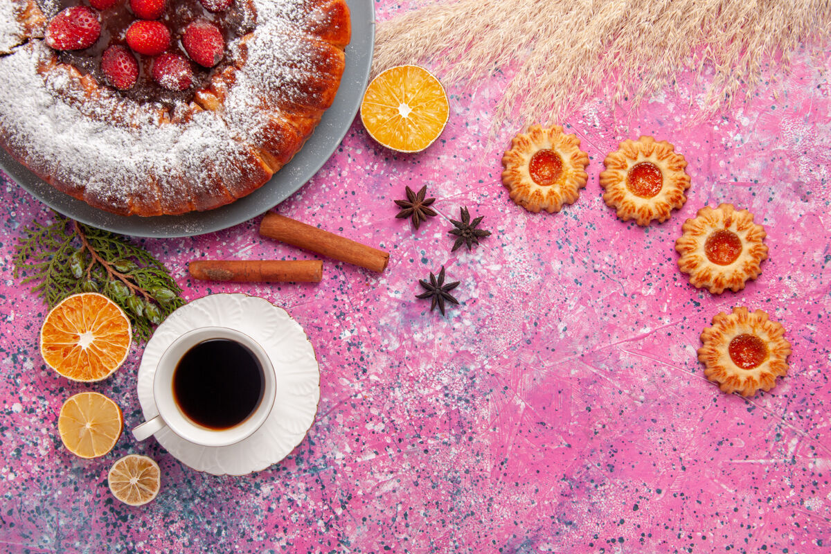 生的俯瞰美味的草莓蛋糕糖粉蛋糕配饼干和一杯茶 背景是粉色蛋糕甜甜的糖饼干饼干馅饼茶热的饮料