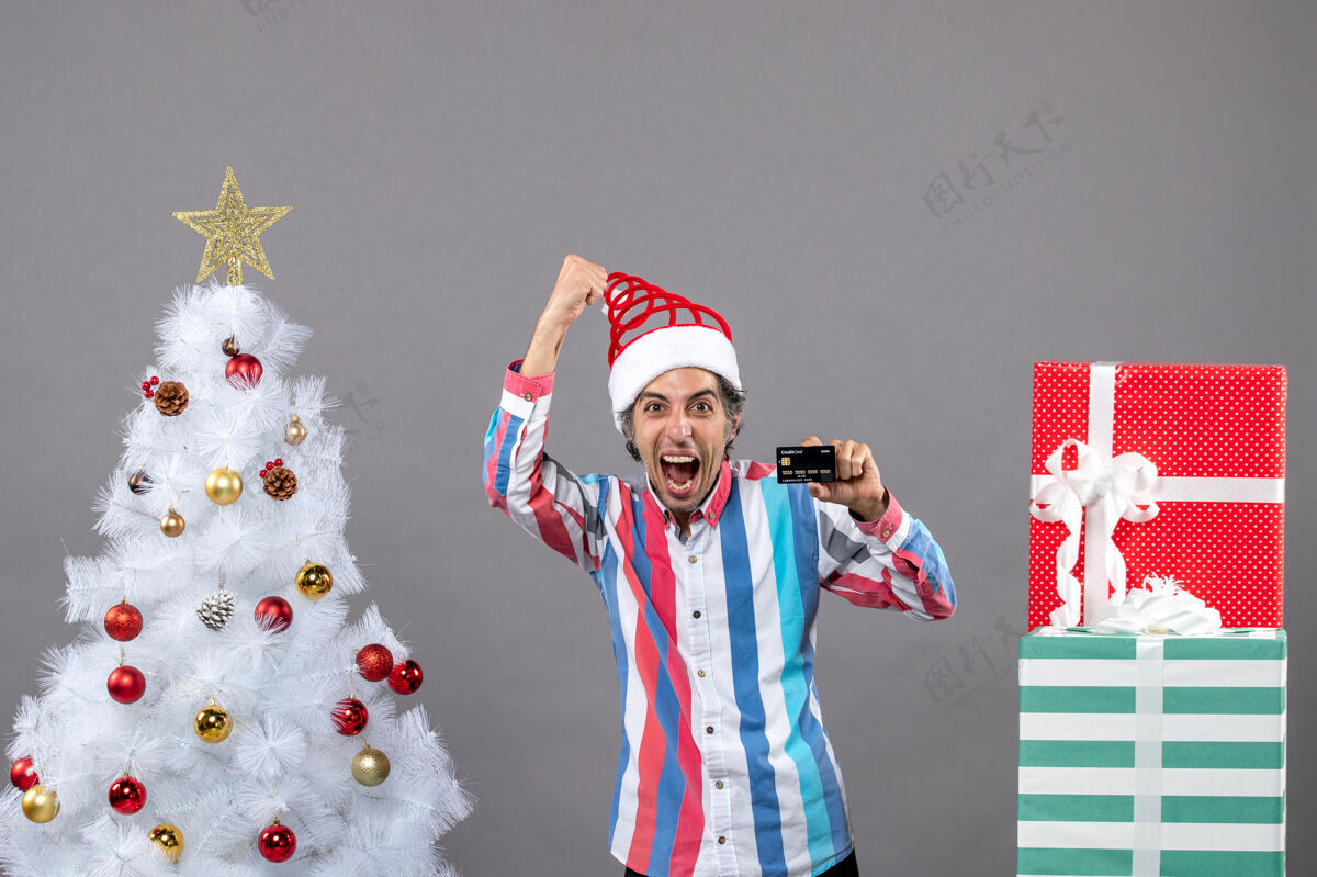 喜出望外正面图是一个欣喜若狂的人站在圣诞树旁 做出胜利的姿态火炬胜利人