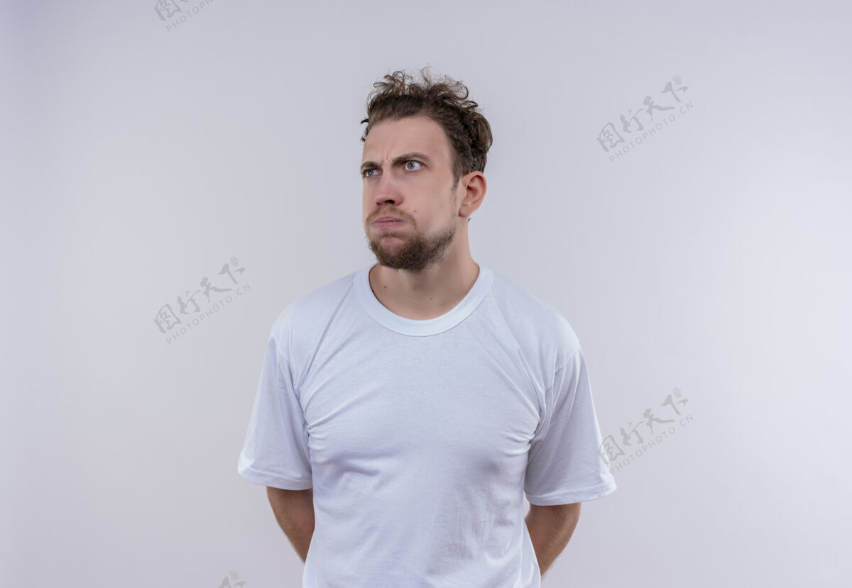 背看着边想边穿白色t恤的年轻人把手放在孤立的白色背景上看白色思考